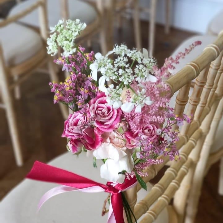 Ceremony chair-back arrangement with ribbon