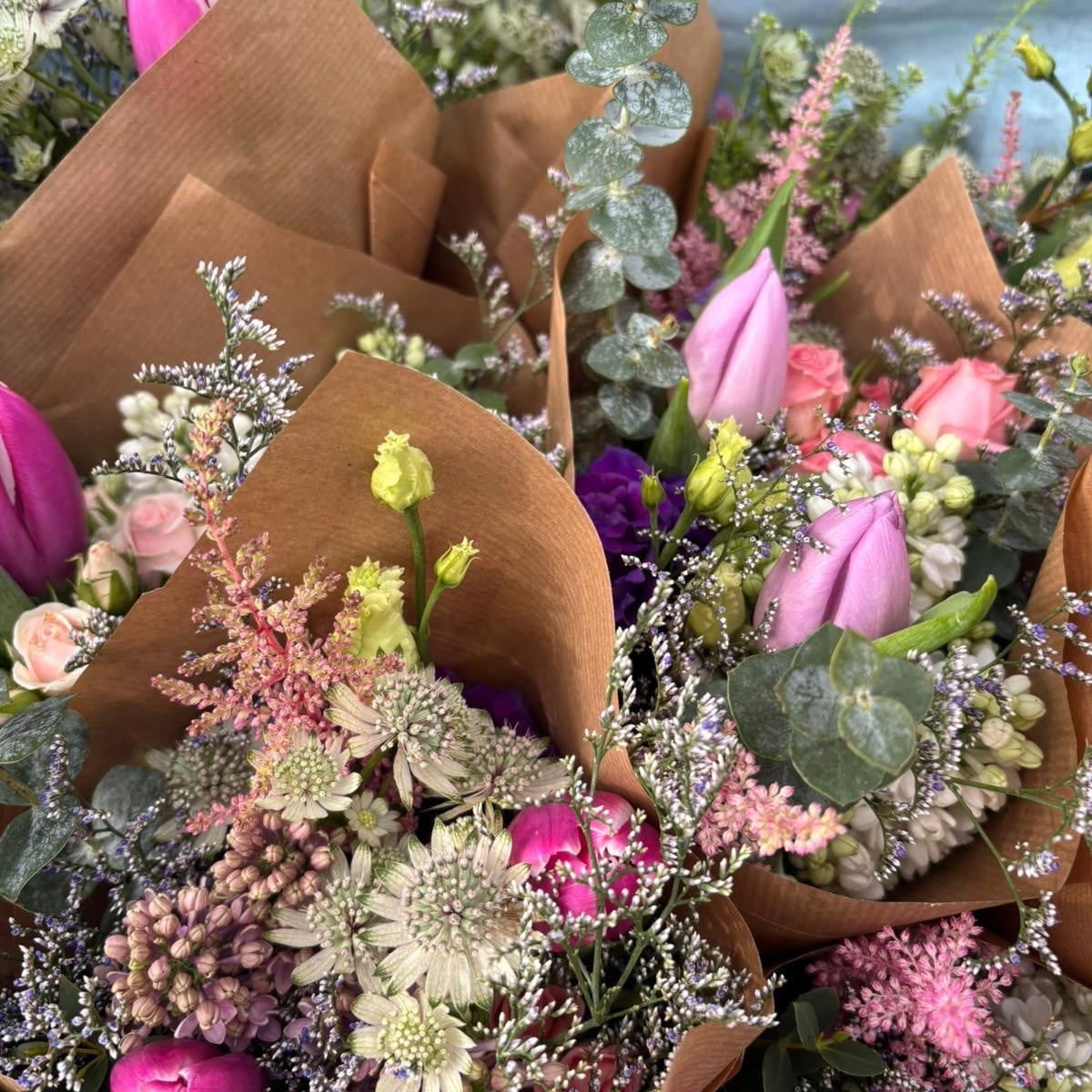 Flat lay of pastel and jewel-toned seasonal bouquets