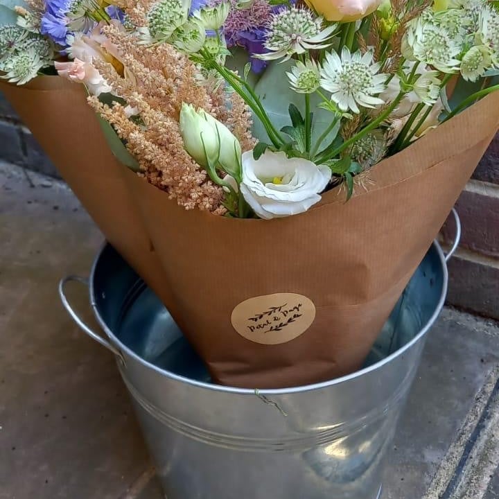 Friday Flowers bunch with Petal & Page label in a bucket